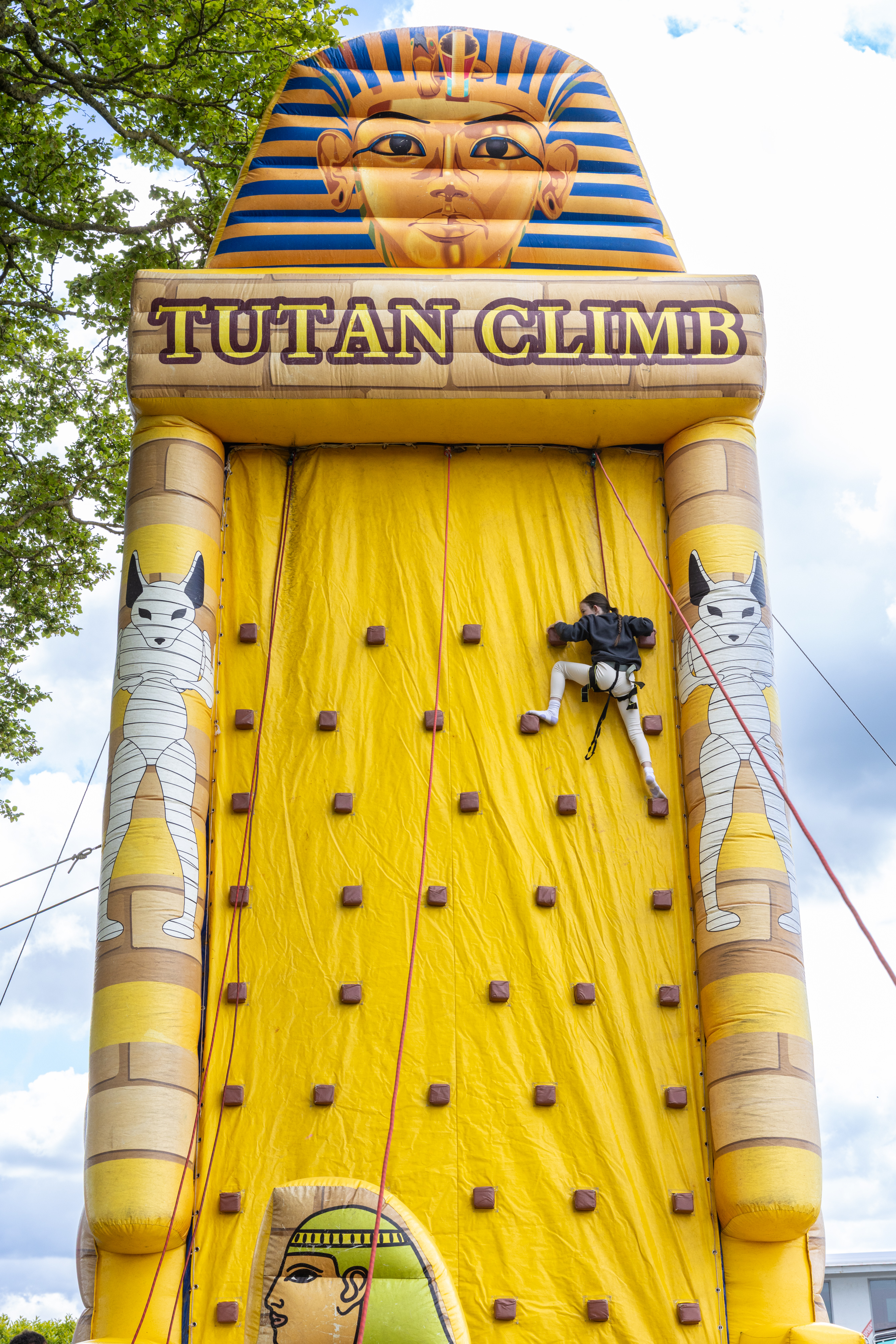 Person climbing bouncy castle.